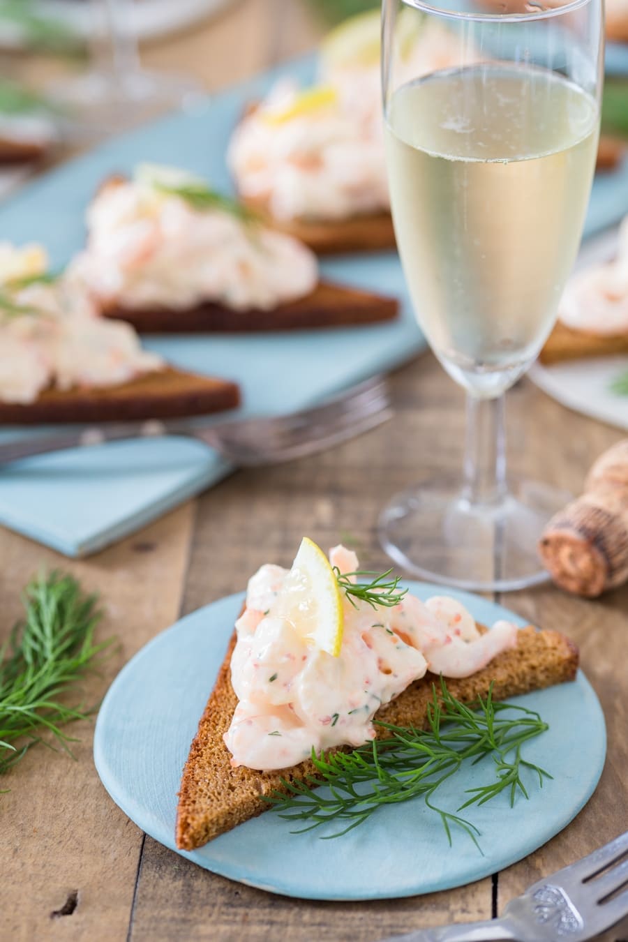Single rye toast topped with skagenröra shrimp salad.
