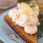 Toast skagen rye bread with skagenröra shrimp salad topping.