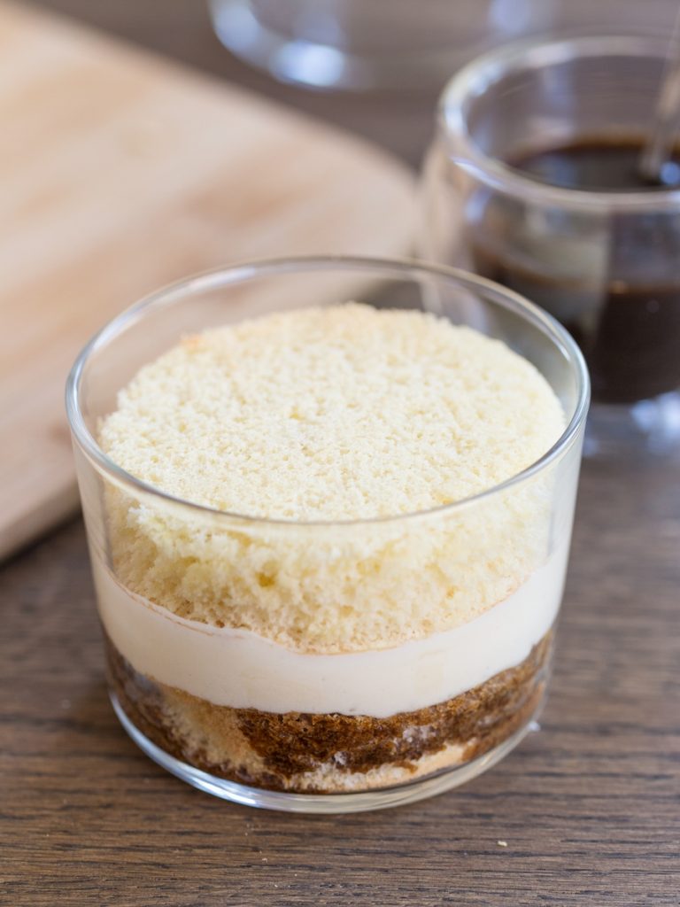 Tiramisu in a glass recipe: the next layer of sponge cake is added to the glass.