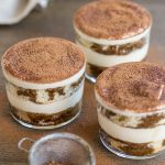 3 cups of tiramisu showing the layers of sponge cake and mascarpone cream.