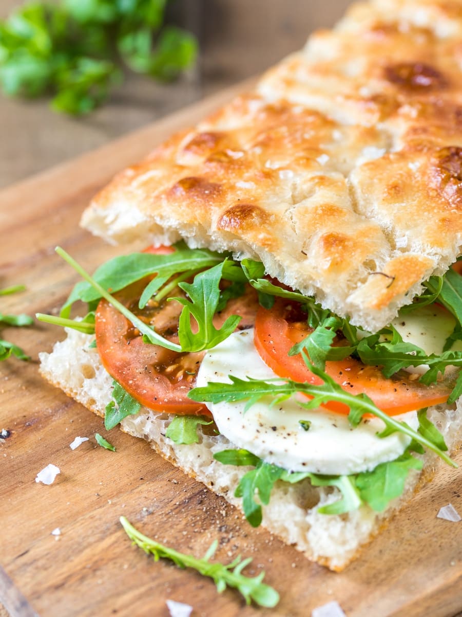 Focaccia filled with caprese salad: tomato and mozzarella on focaccia bread.