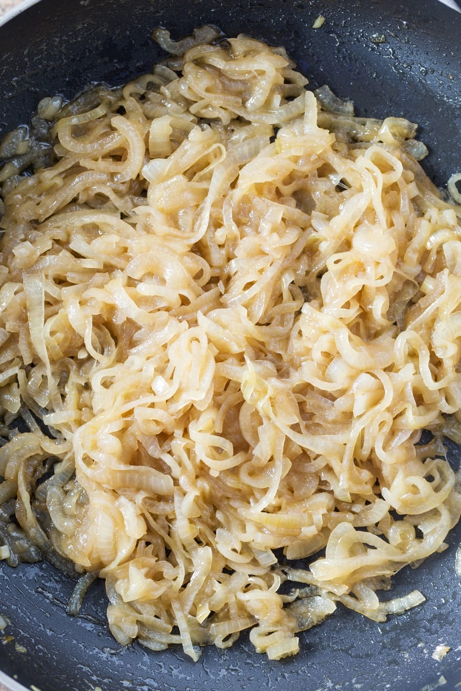 Marsala caramelized onions in a skillet.