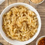 Overhead view of marsala caramelized onions in a bowl.