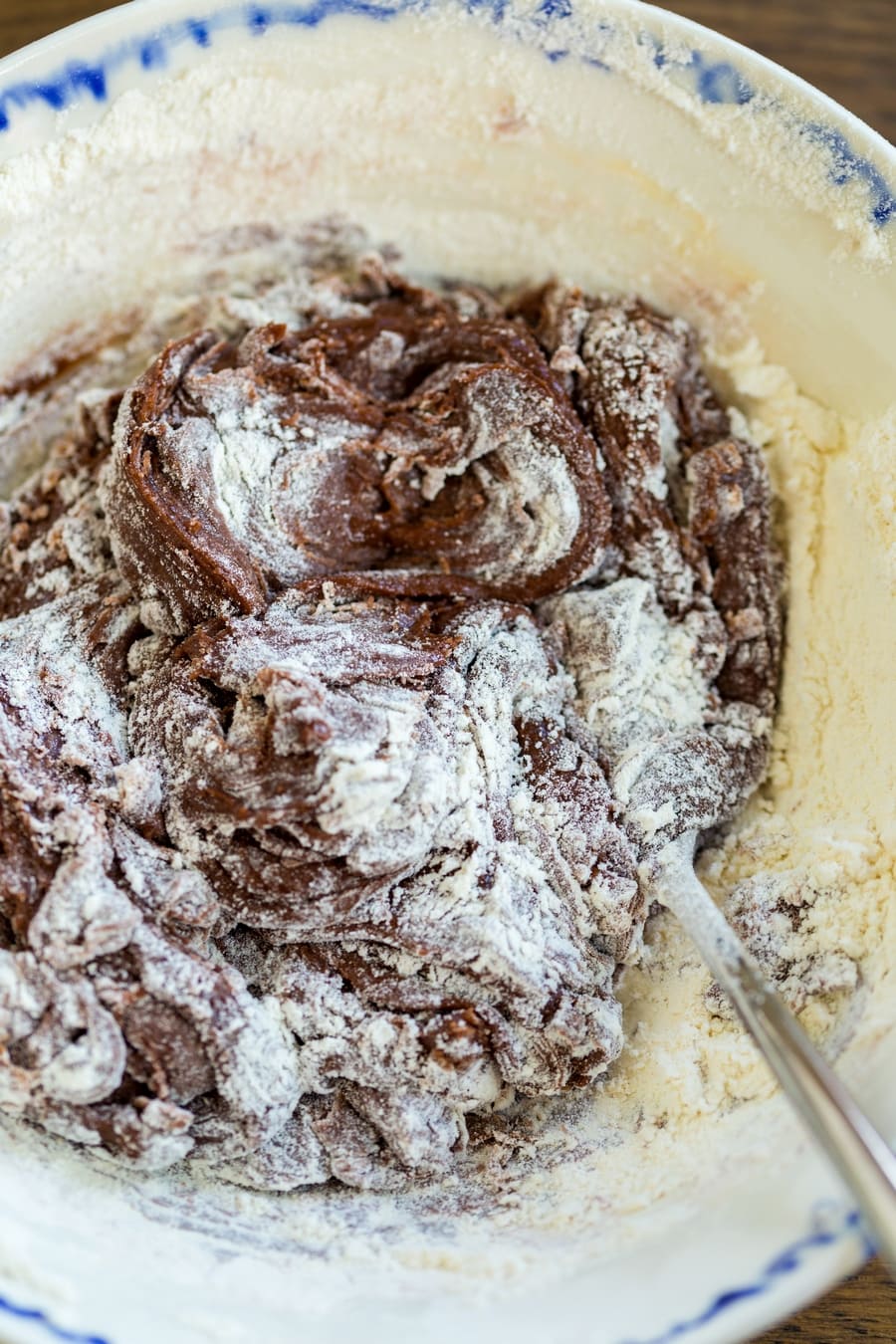 Incorporating flur to egg and Nutella mixture to make nutellotti.