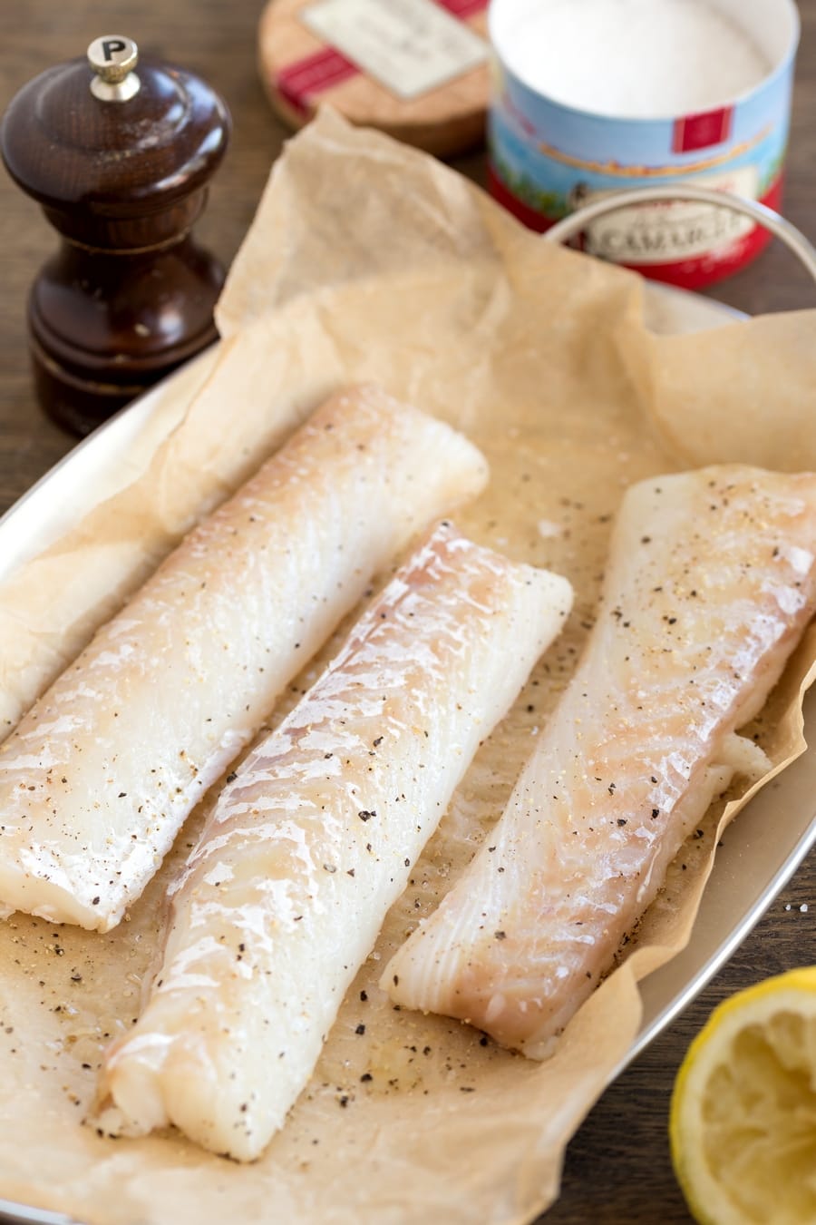 Cod fillets seasoned with back pepper and lemon juice.