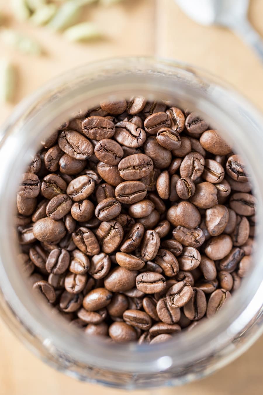 Coffee beans in a mason jar, overhead.
