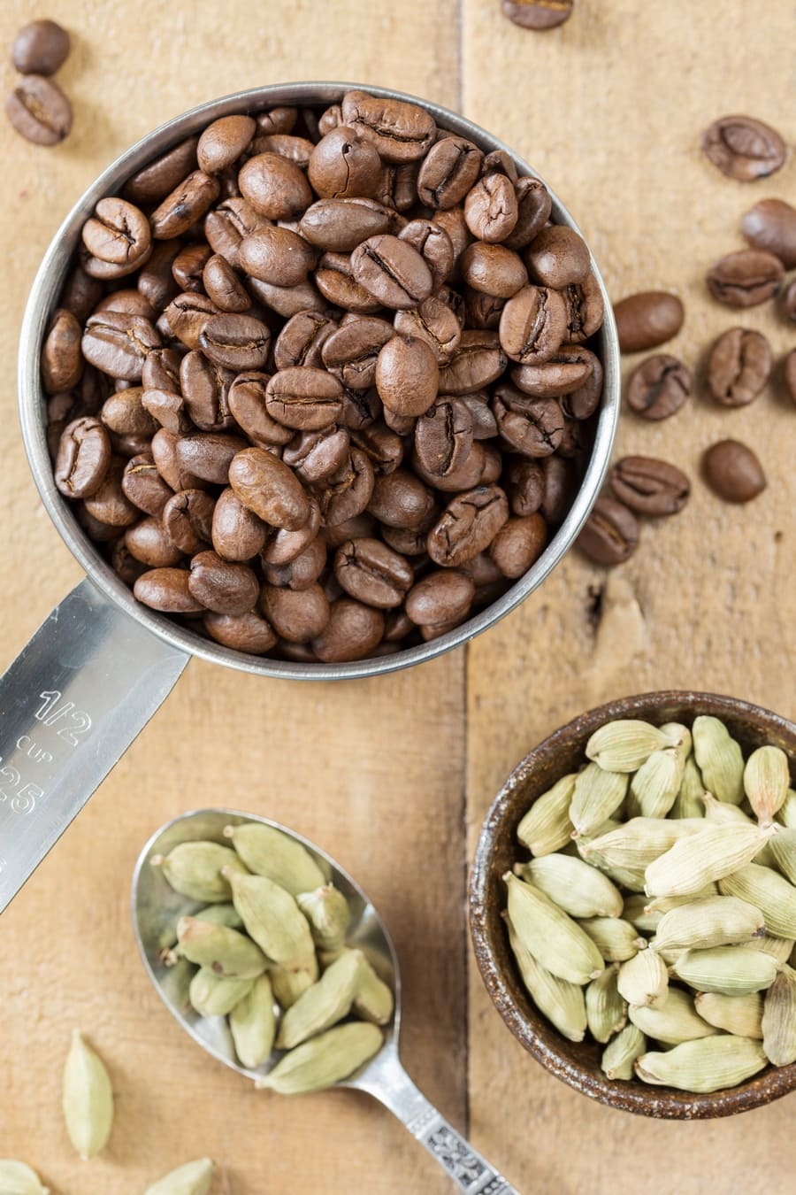 Overhead view of coffee beans and cardamom pods.