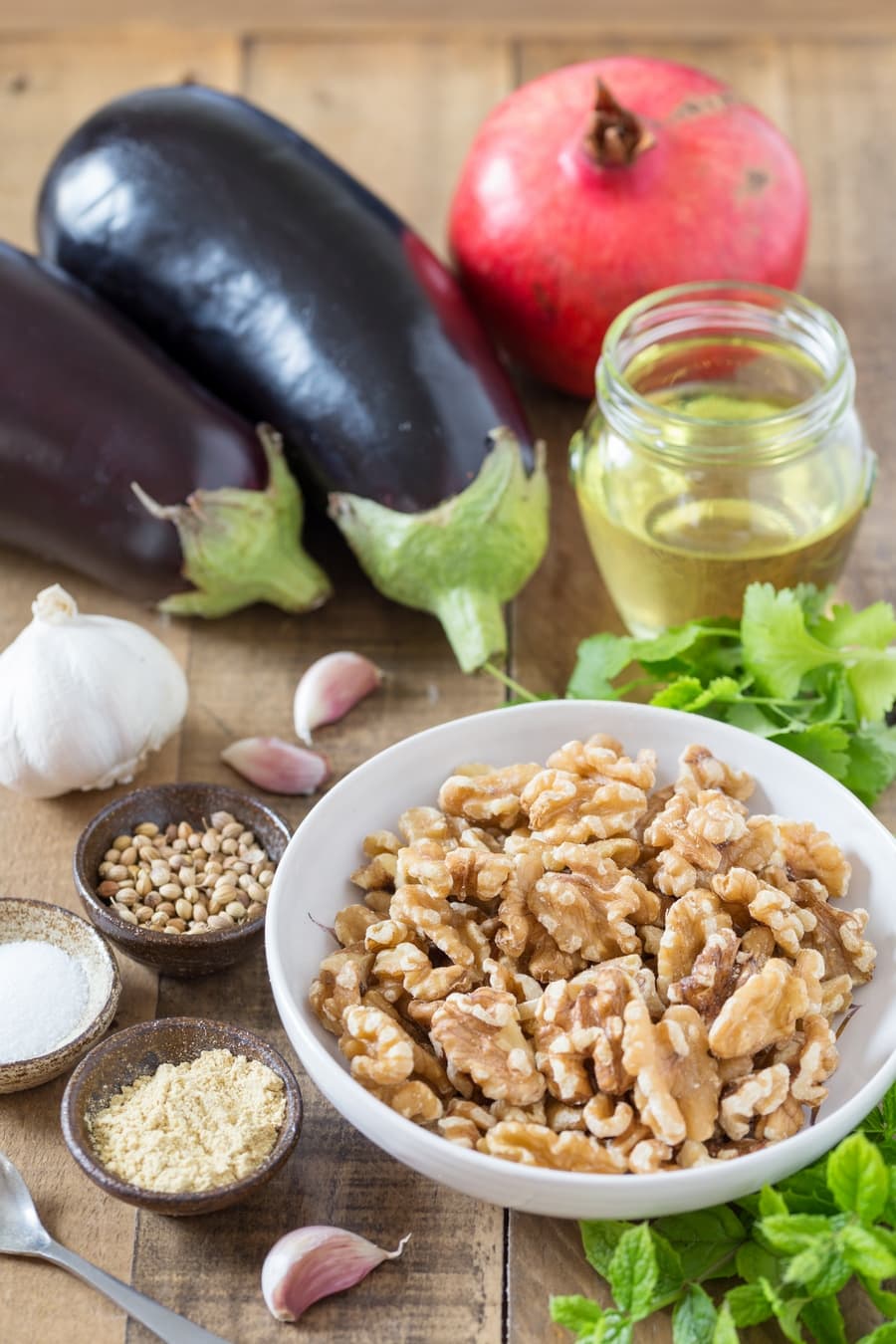Walnuts, eggplants, fresh herbs and spices, garlic, oil, pomegranate.