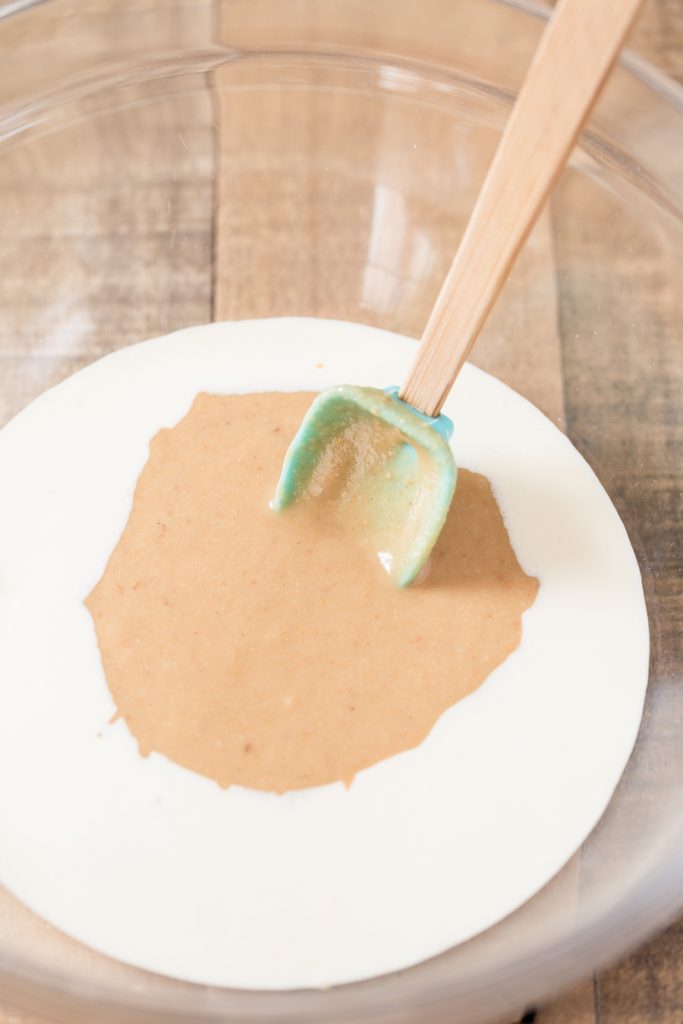 Making hazelnut no-churn ice cream: hazelnut paste added to whipping cream.