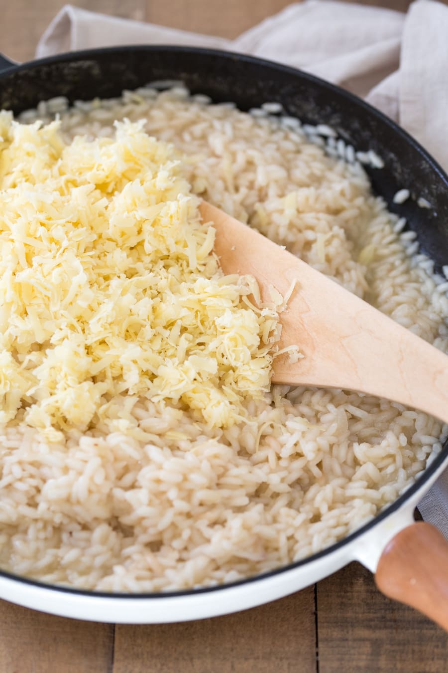 Zucchini cheddar risotto preparation: cheddar added to the rice.