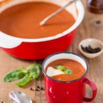 Polish tomato soup served in a small metal cup.