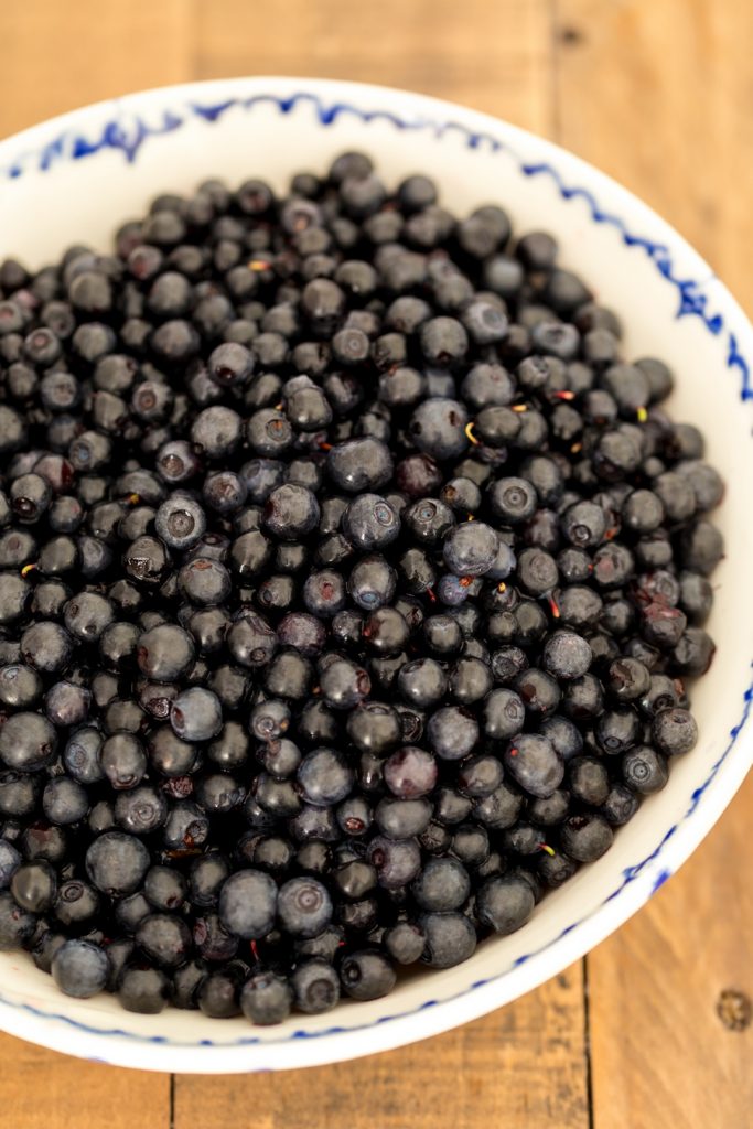 Fresh bilberries in a ceramic bowl.