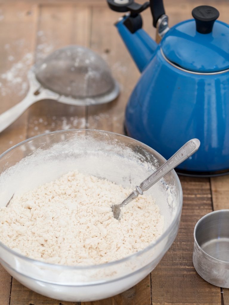 Pierogi dough in the making: bowl of flour to be mixed with hot water.