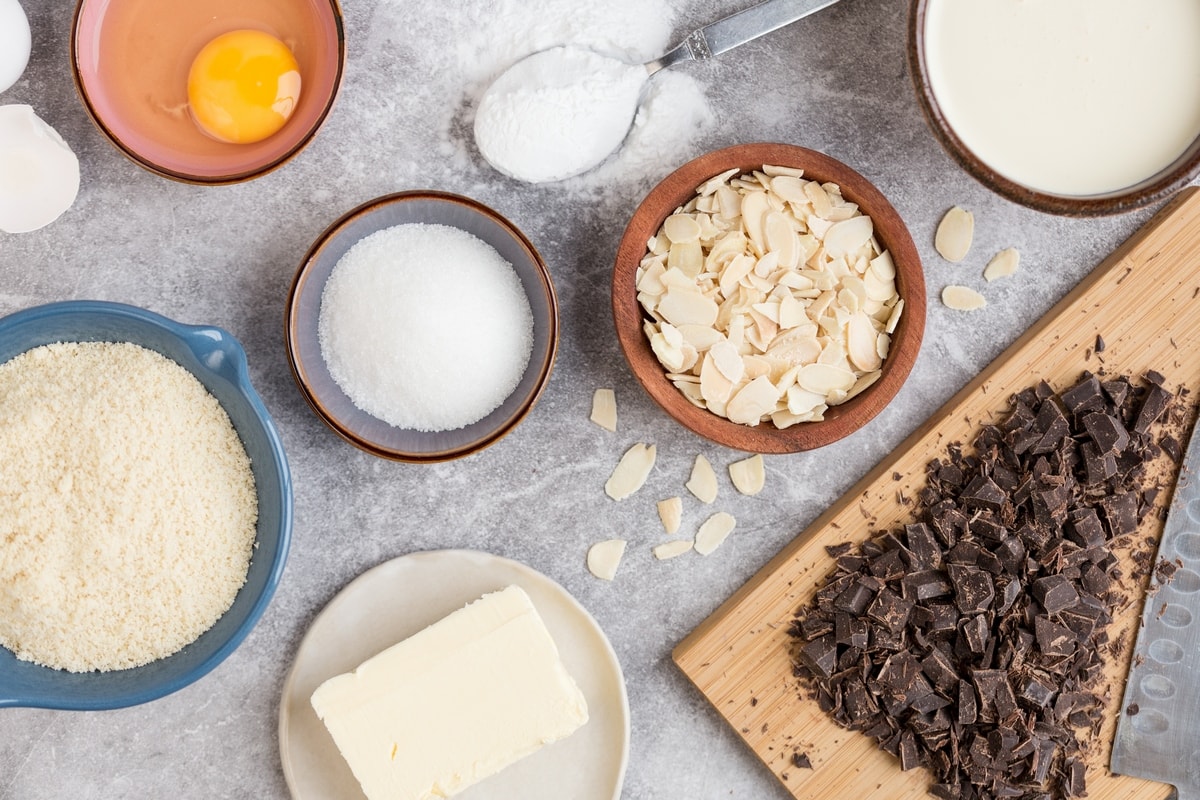 Small bowls containing ingredients needed to make chocolate almod tart.