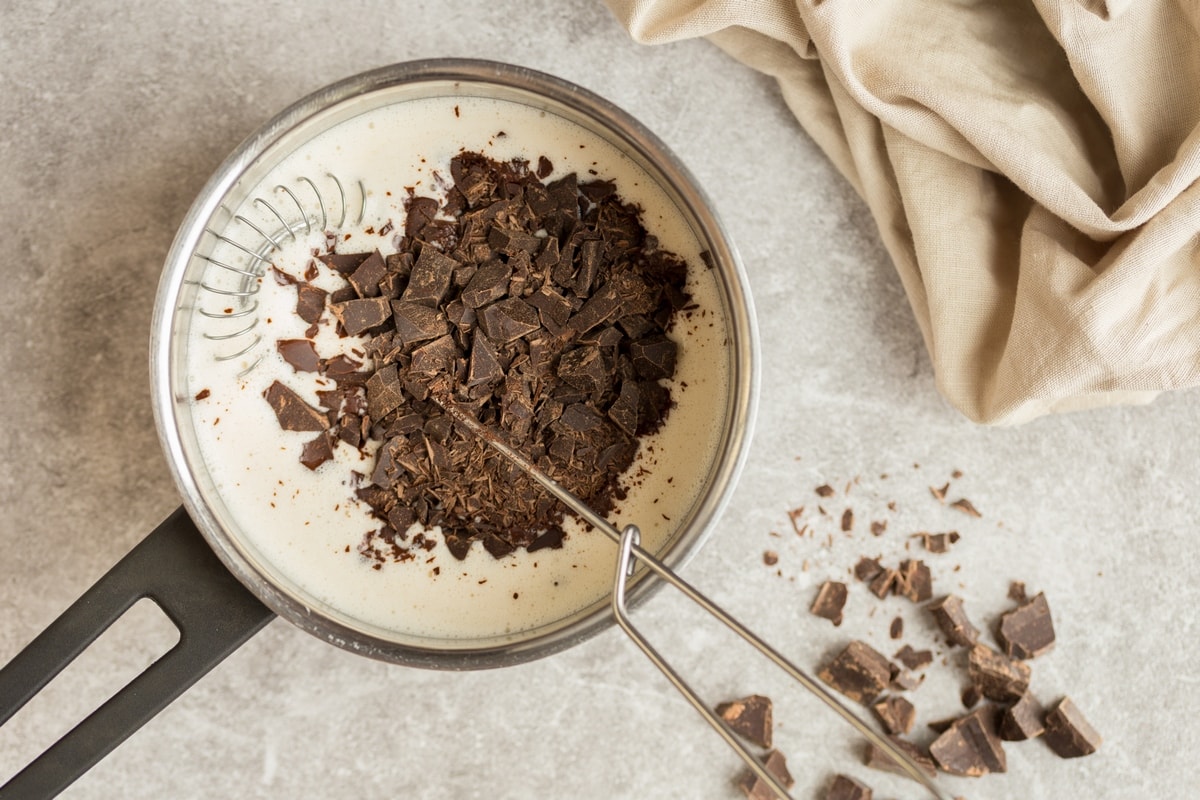 Chopped chocolate added to hot cream.