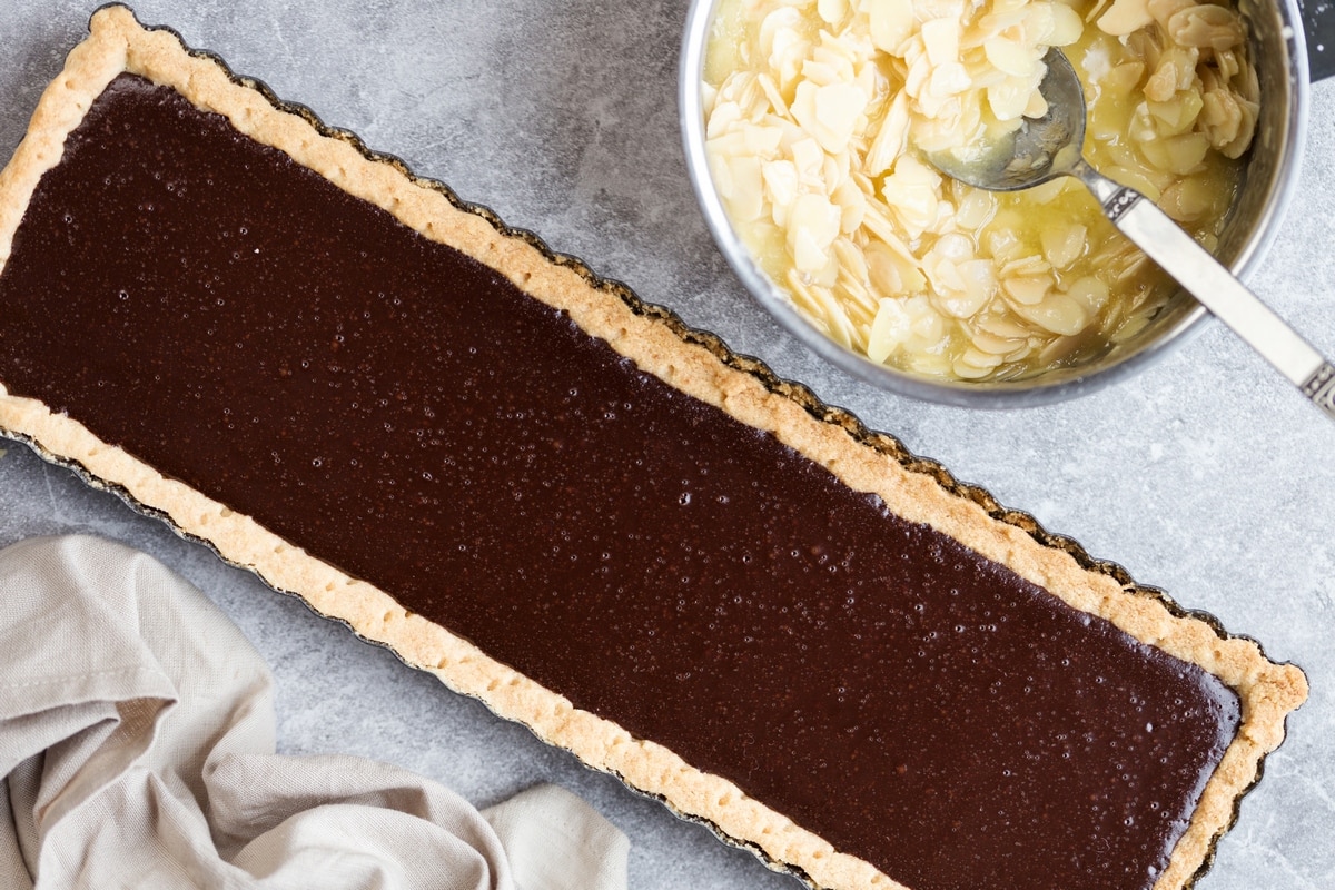 Half-baked chocolate tart, almond glaze topping on the side.