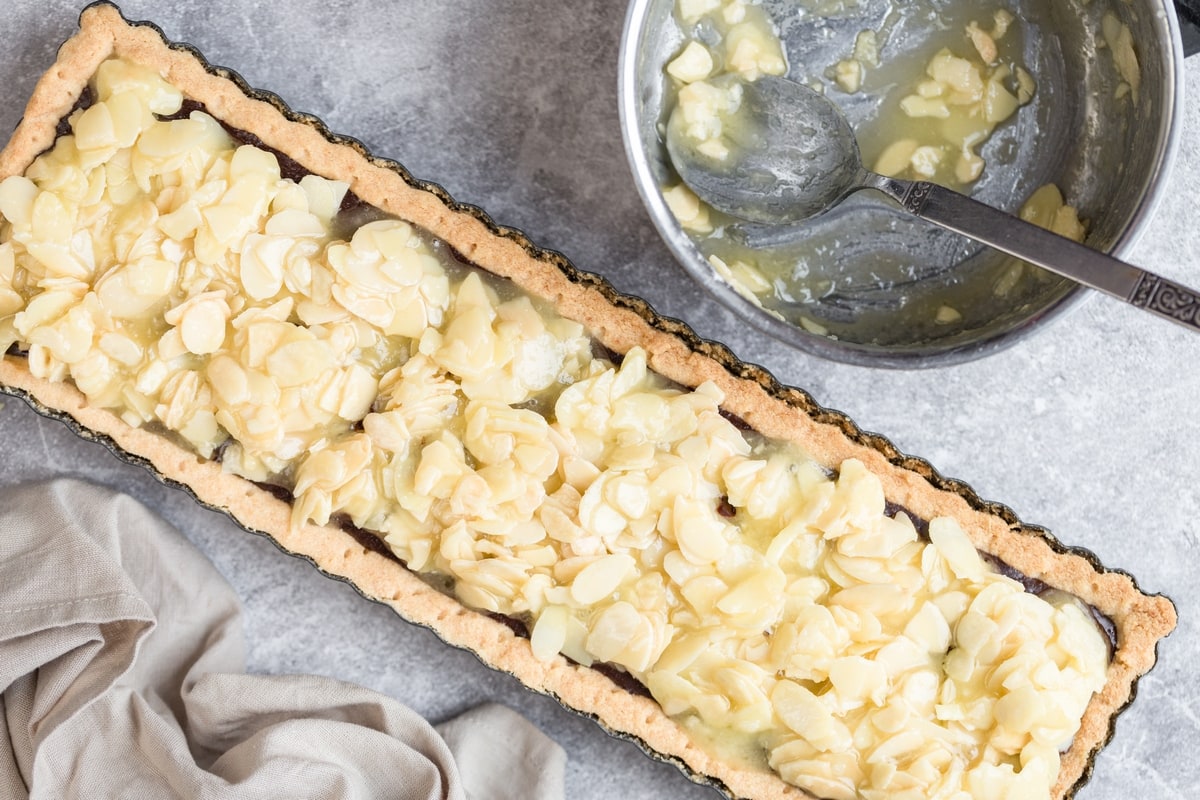 Glazed almond topping added to chocolate almond tart.