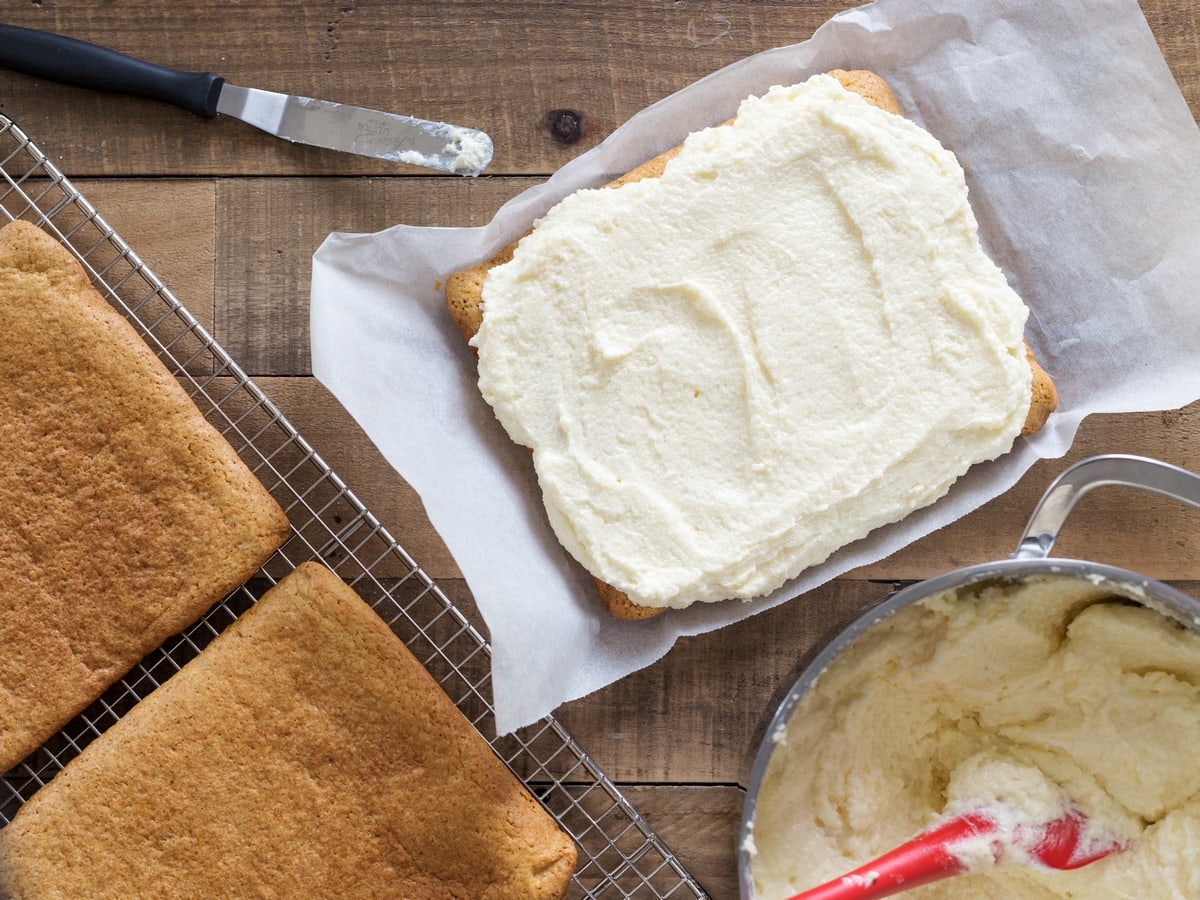 Semolina cream layer spread over honey cake.