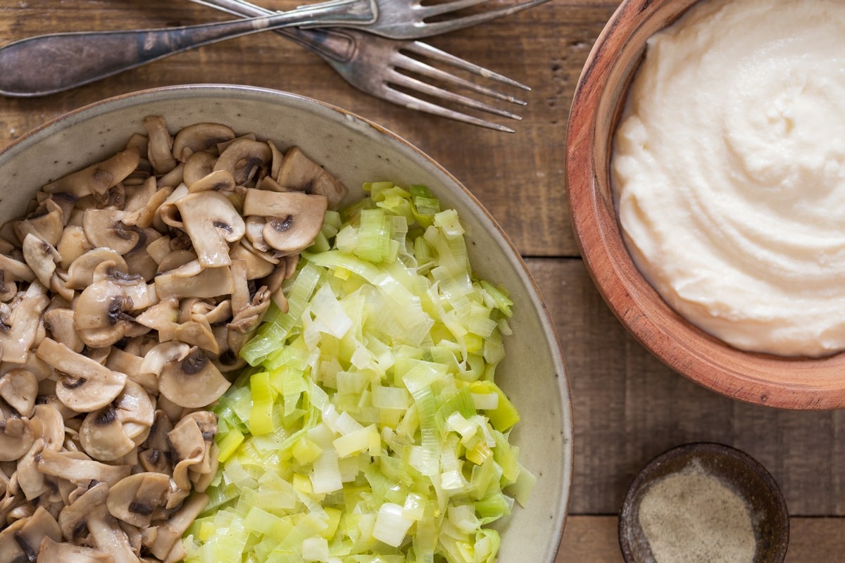 Sautéed leeks and sautéed mushrooms, a bowl of ricotta on the side.