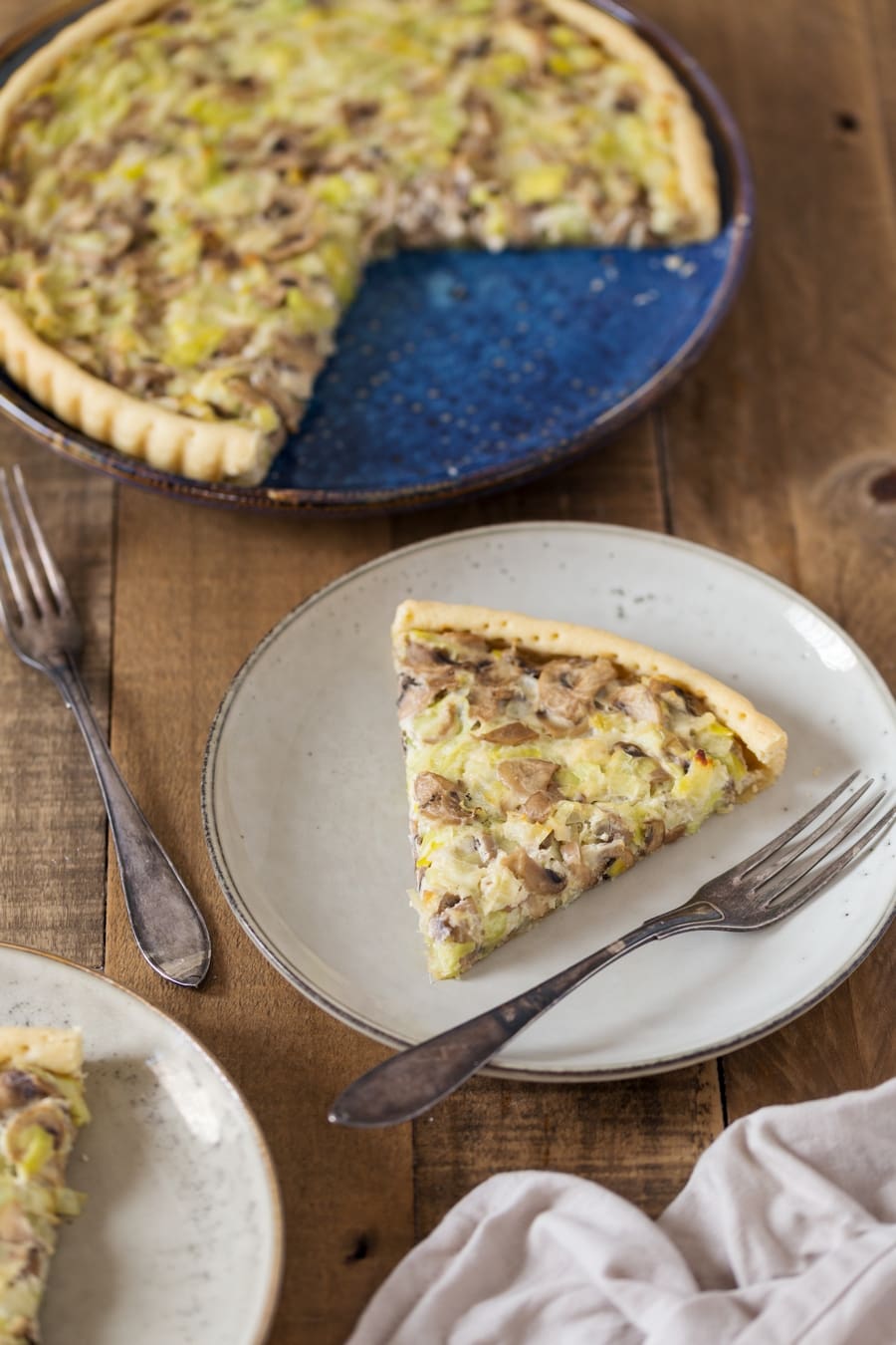 Slice of mushroom ricotta pie on a plate.