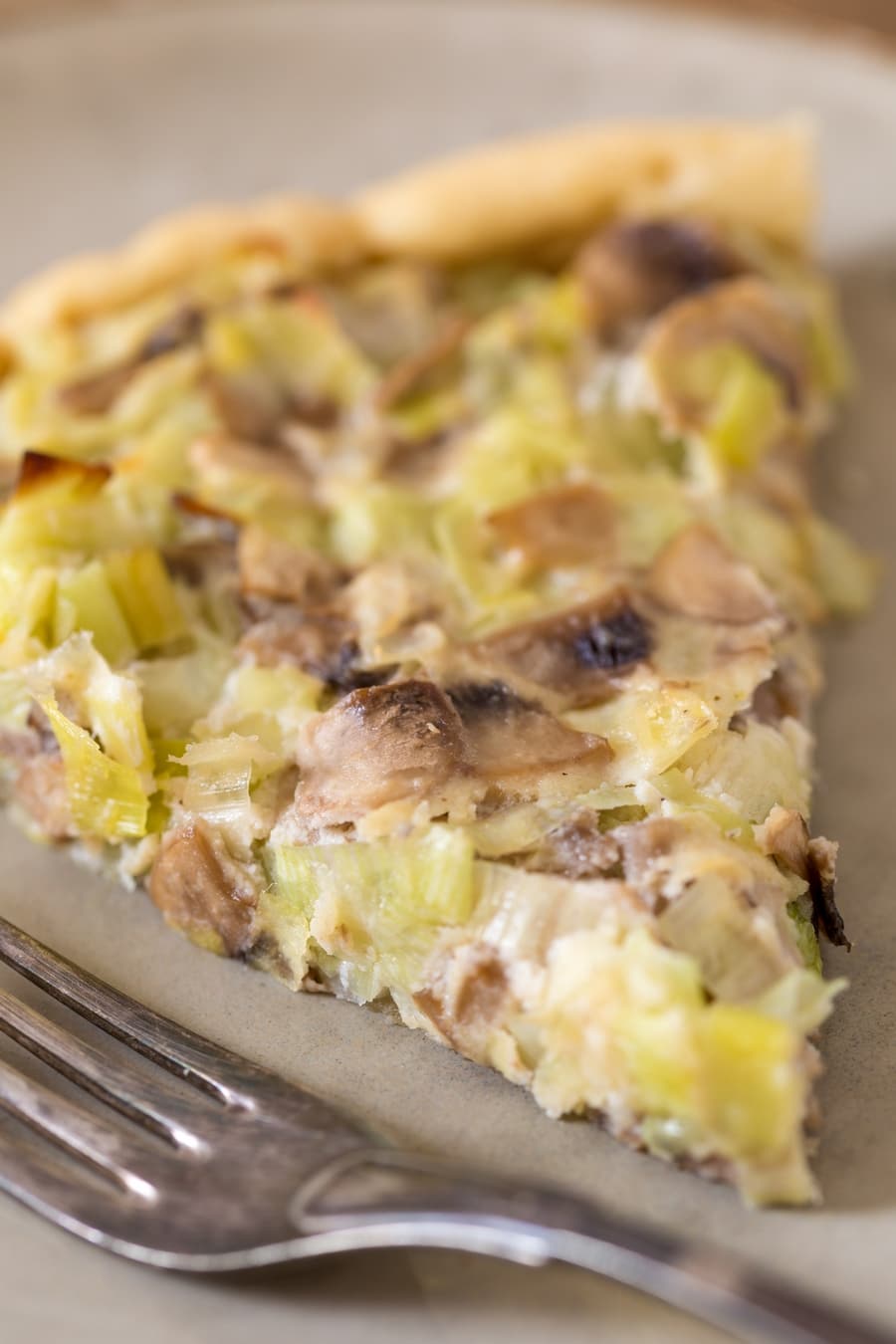 Closeup of mushroom ricotta pie with leeks.