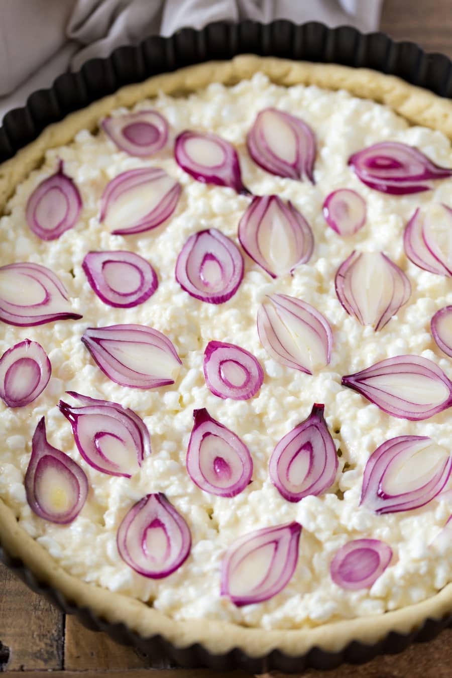 Sliced pearl onions added to cottage cheese pie filling.