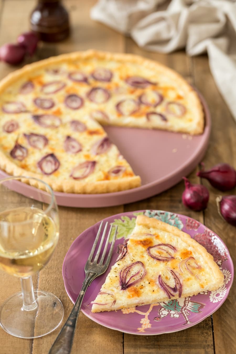 Sliced cottage cheese onion tart, white wine on the side.