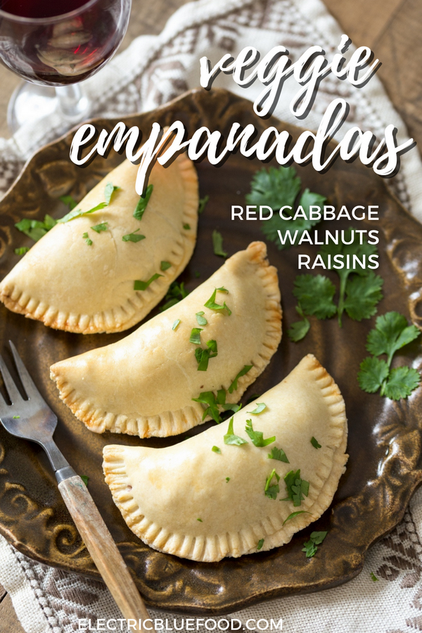 Veggie empanadas: a vegetarian version of the popular Argentine turnovers. A filling made of sautéed red cabbage, red onion, raisins and walnuts is enclosed inside a flaky pastry shell to make a delicious veggie dish.