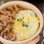 A serving of polenta concia with creamy chanterelle sauce.