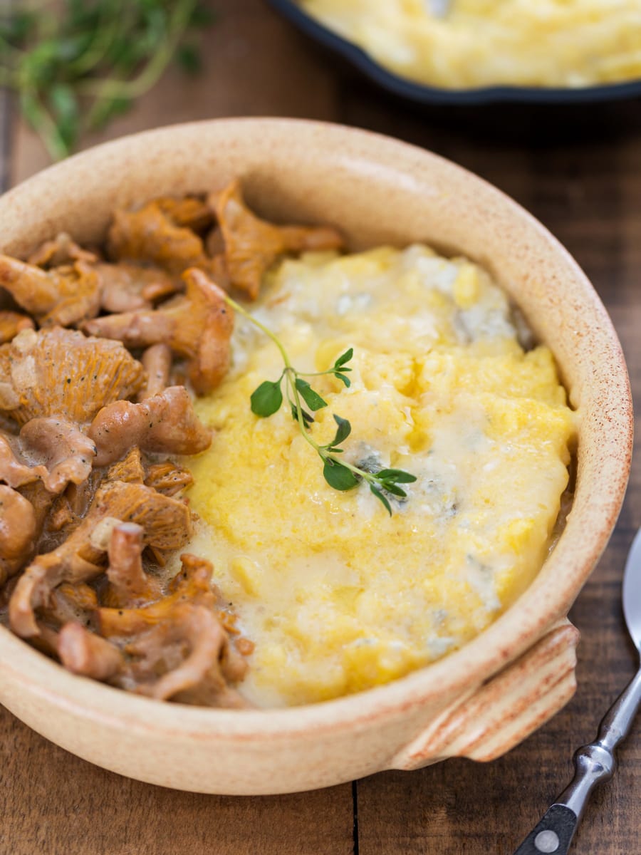 A serving of polenta concia with creamy chanterelle sauce.