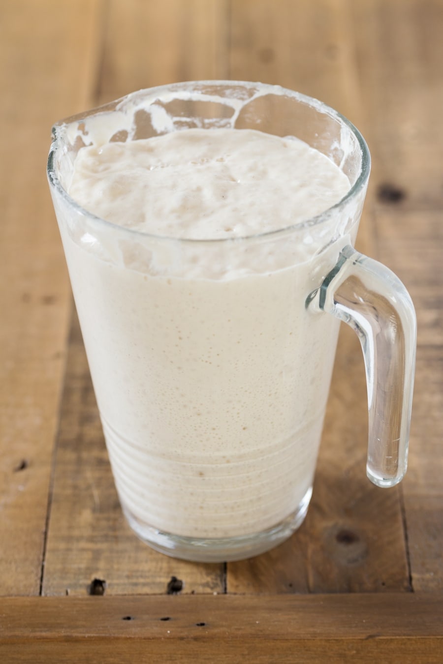 A jug containing a fully mature poolish pre-ferment.