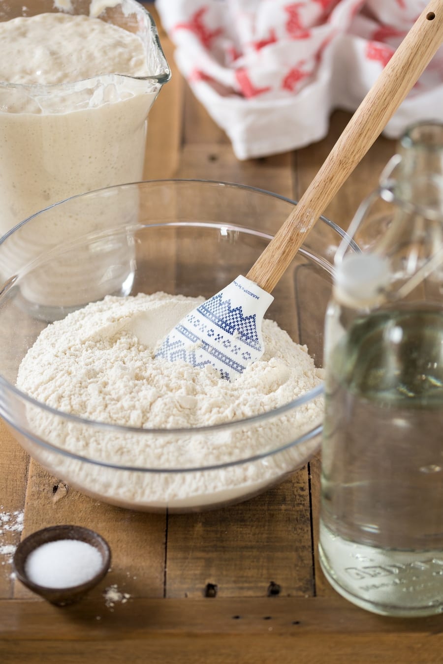 Bowl of flour, water and poolish on the side.