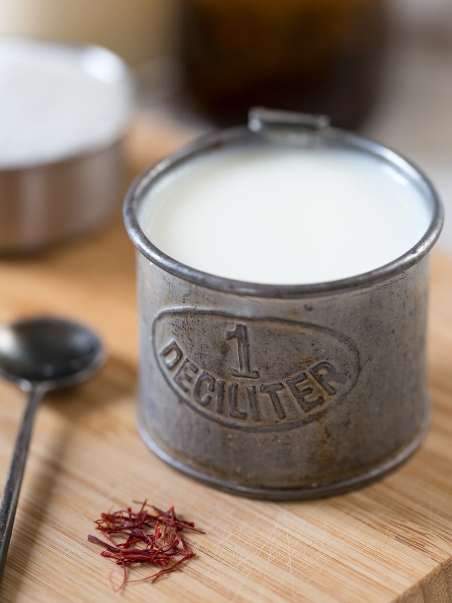 Milk in a tin deciliter container.