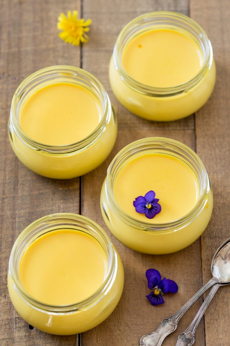 Saffron panna cotta in small glass jars.