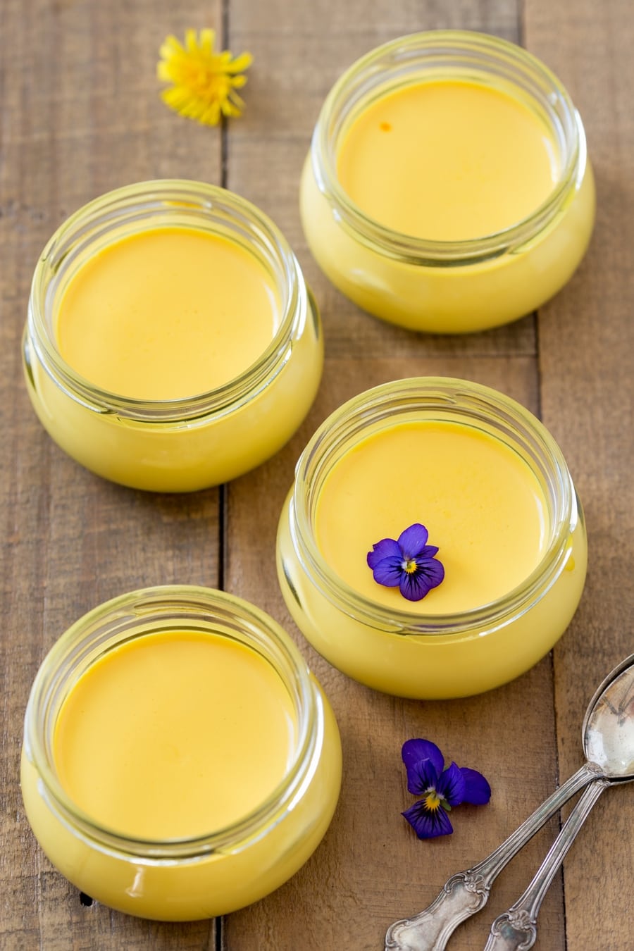 Saffron panna cotta in small glass jars.