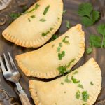 Baked empanadas on a plate.
