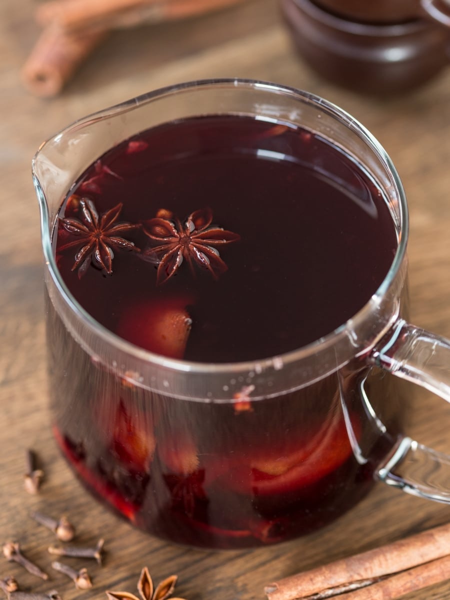 Glass jug with vin brulé. Star anise pods on the surface.