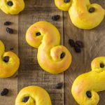 Overhead view of saffron buns on a table.
