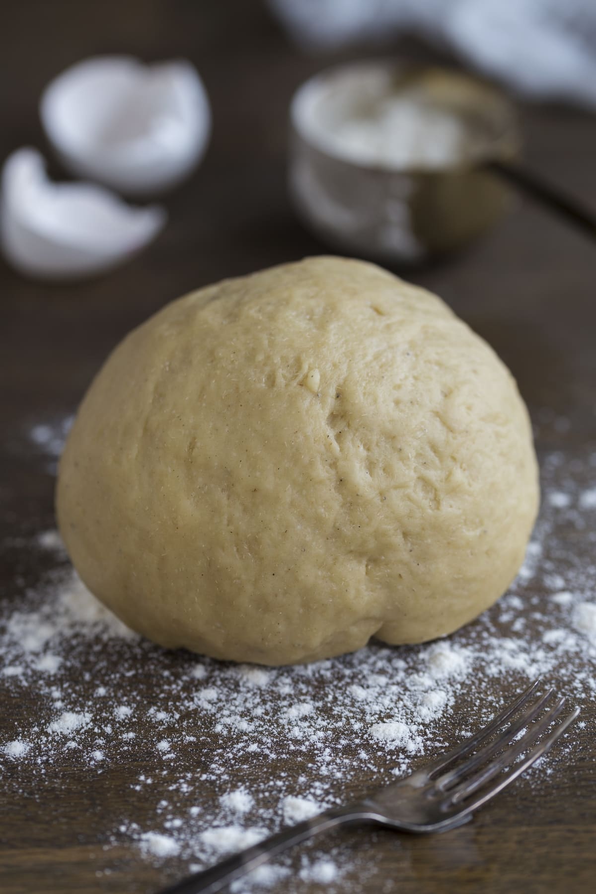 A ball of yeast dough on a floured surface.