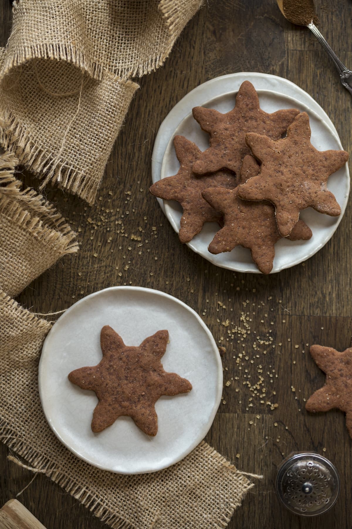 Swedish gingerbread biscuits on white plates on a wooden table.