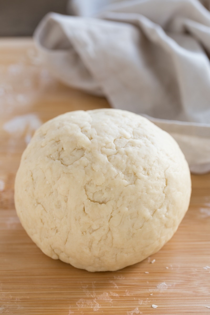 Dough ball on a wooden surface.