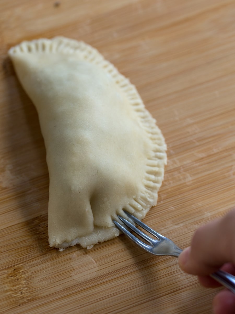 Fork sealing empanada edges.