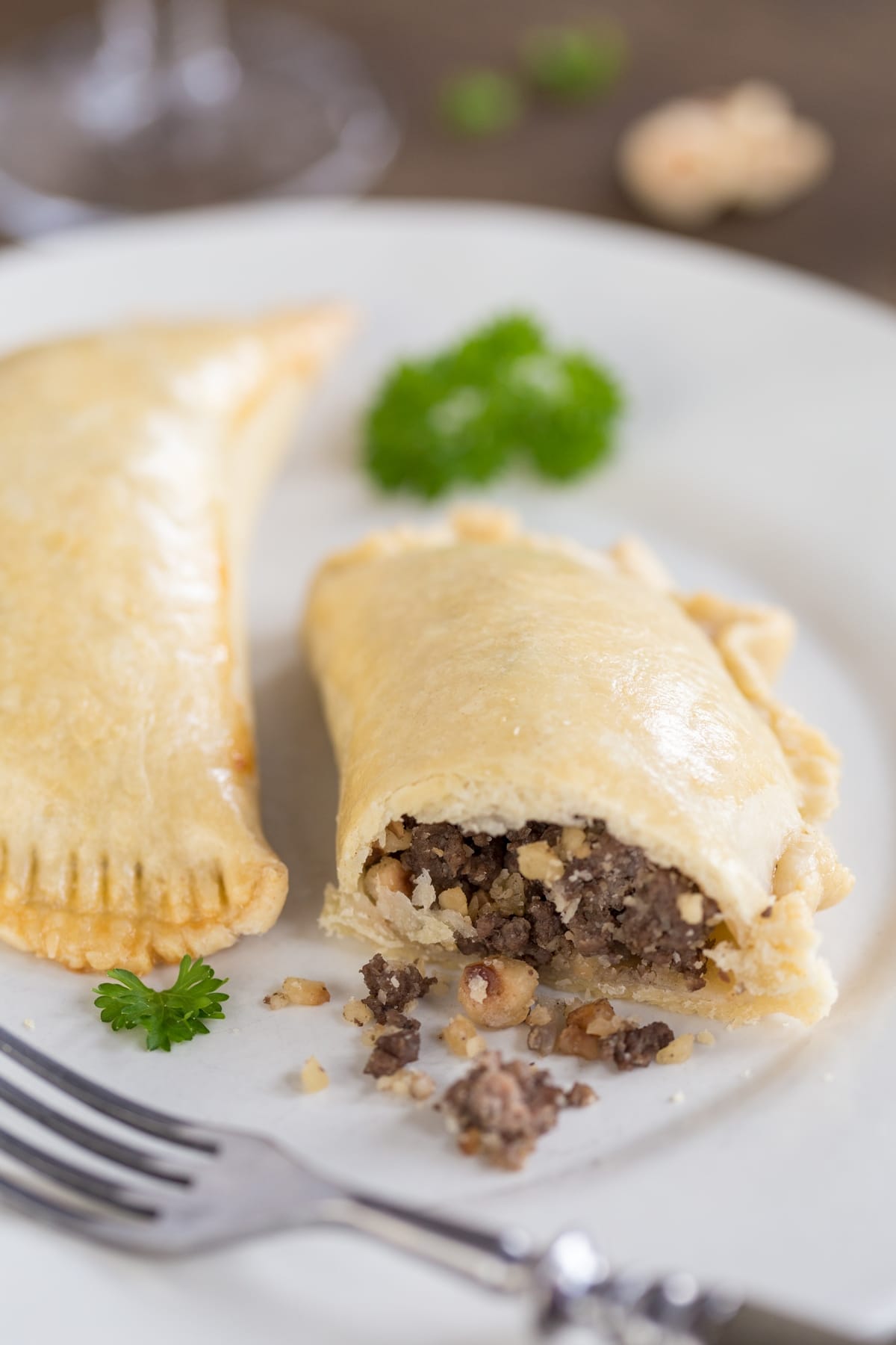 Homemade empanadas with venison and hazelnut filling, with filling coming out.