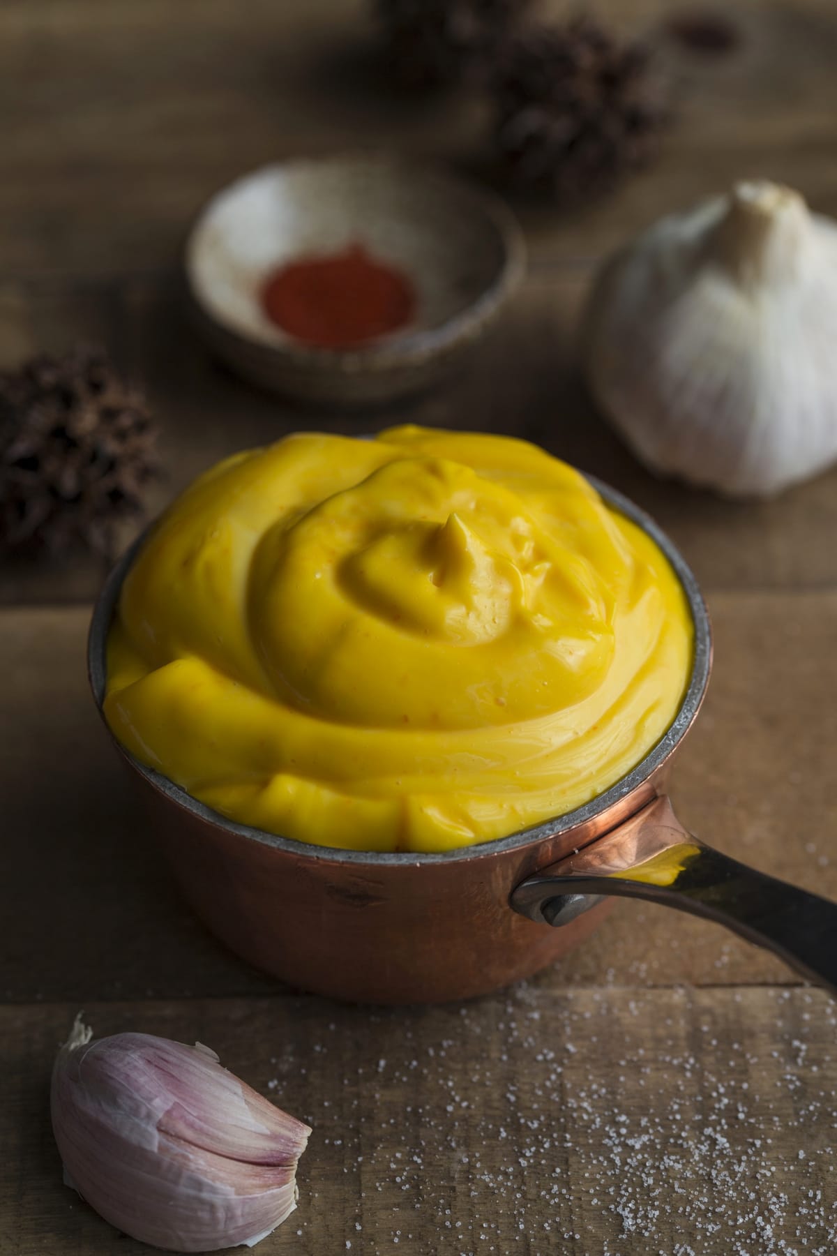 Garlic mayonnaise with saffron in a copper saucepan.