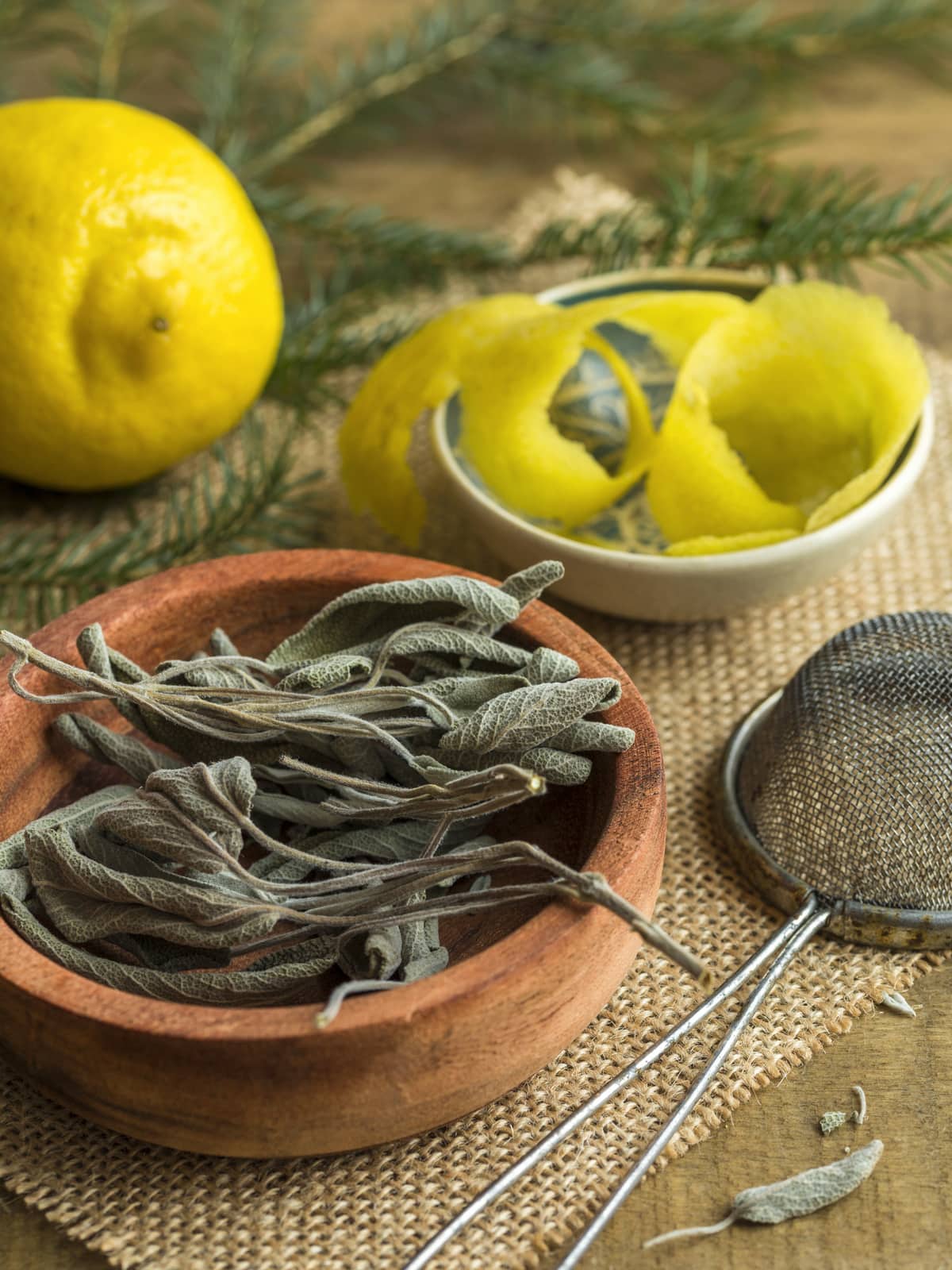 Dried sage leaves, a lemon and some lemon zest.