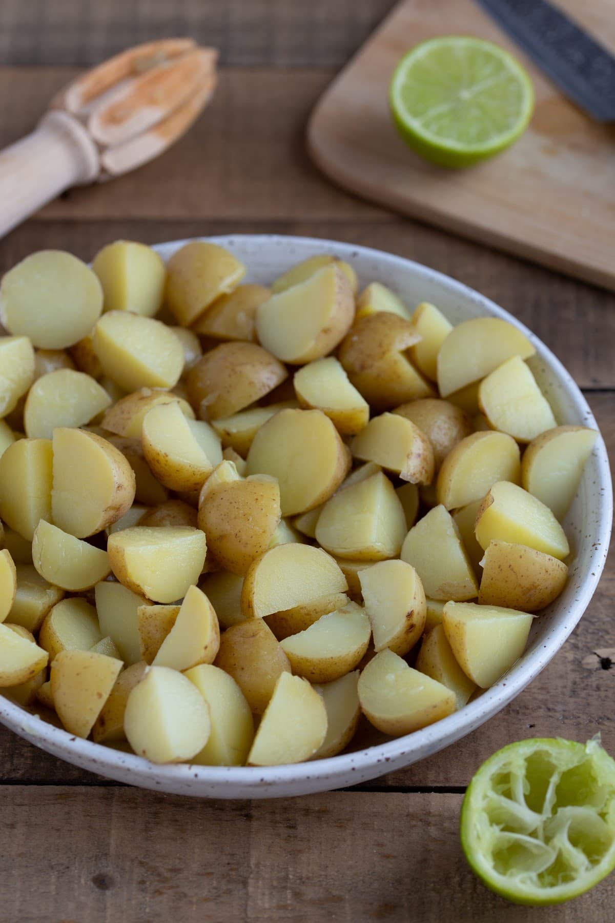 Baby potatoes, cooked, cut in quarters and placed in a bowl.