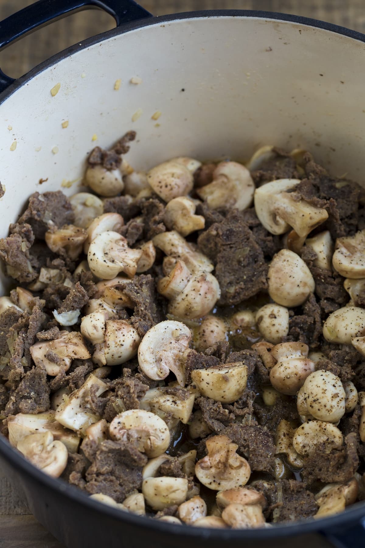 Reindeer meat and mushrooms cooking with white wine.