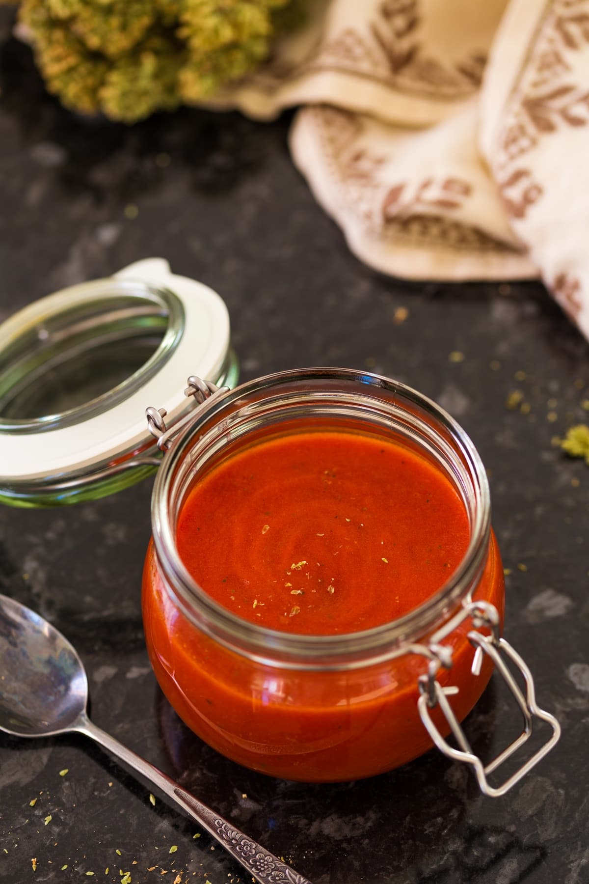 Pizza sauce in a glass jar.