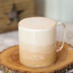 London fog tea latte in a glass mug showing the milk layering over the tea.