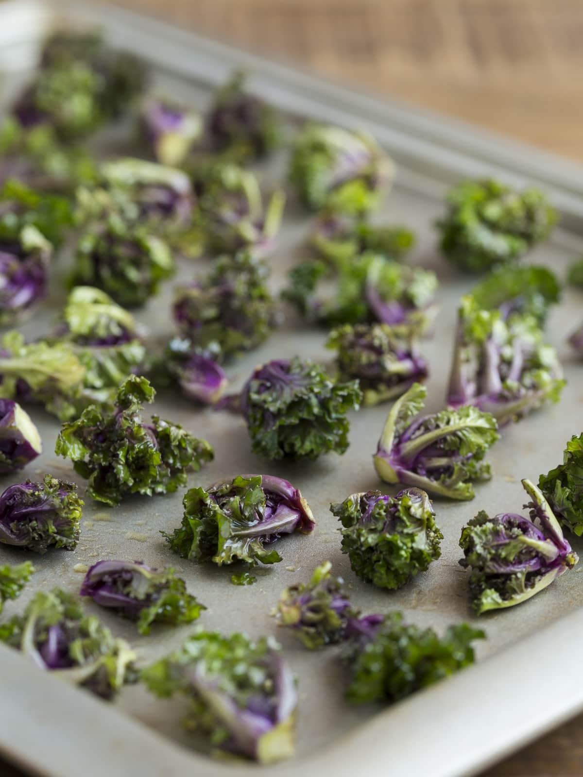Flower sprouts tossed in olive oil and places on a sheet pan to bake.
